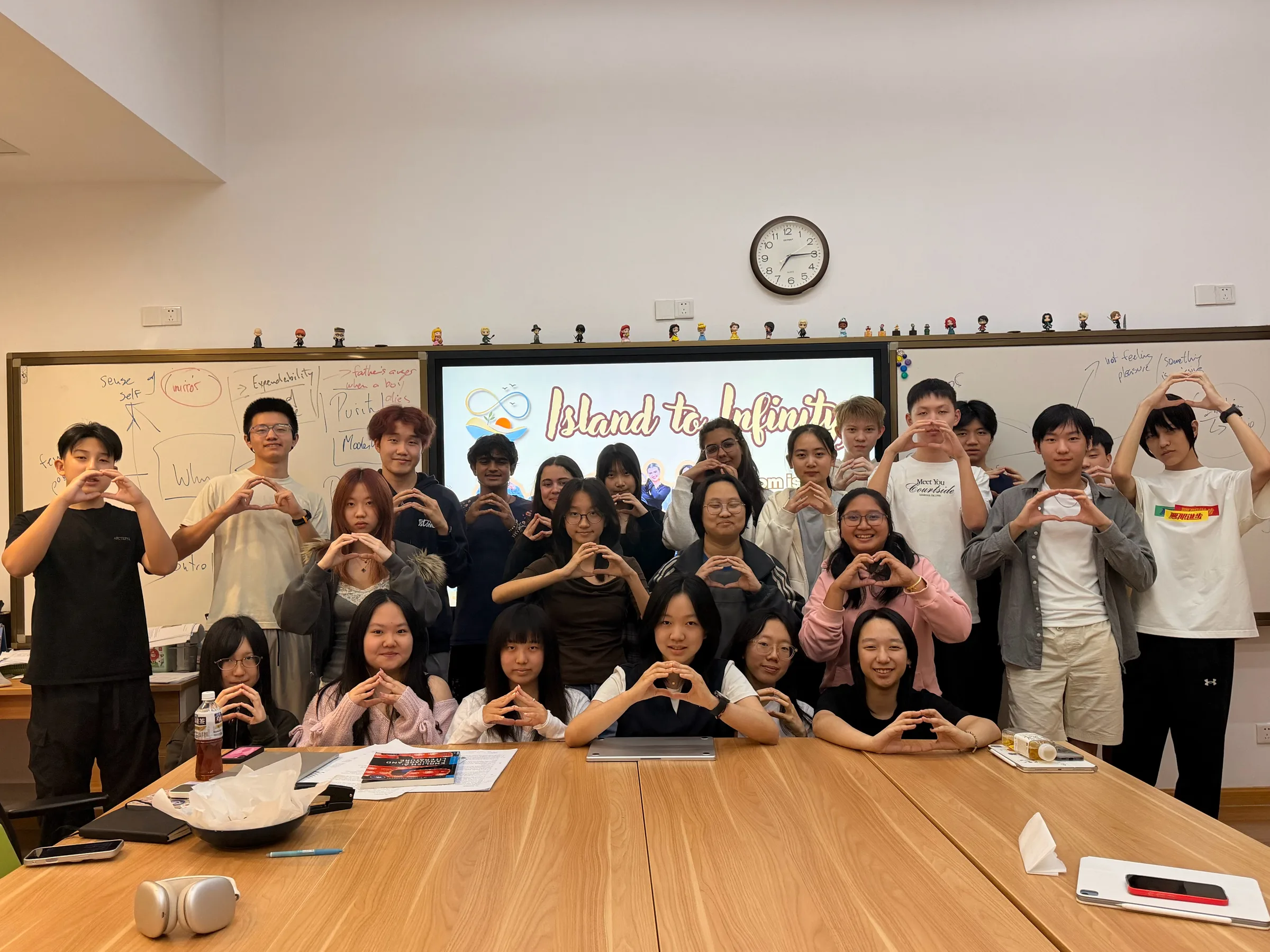 Island to Infinity members making heart gestures together at UWC Changshu